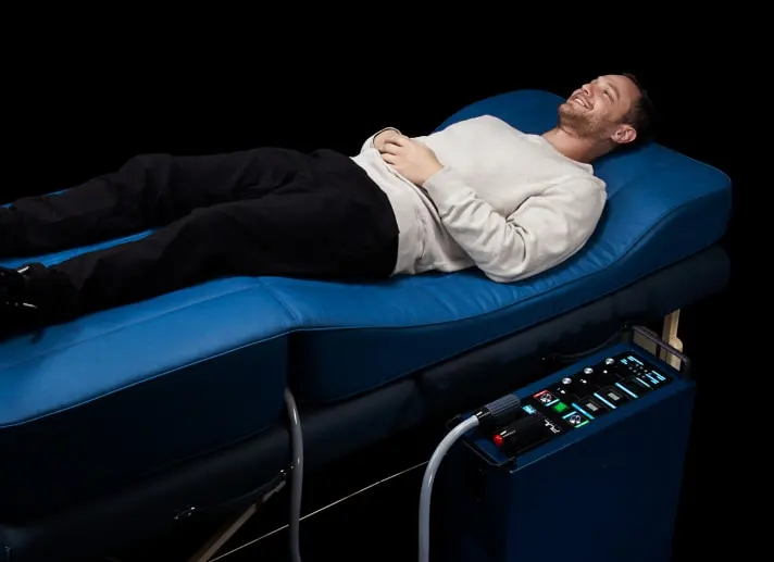 Guest relaxing on a PEMF therapy bed at iCRYO Port St. Lucie