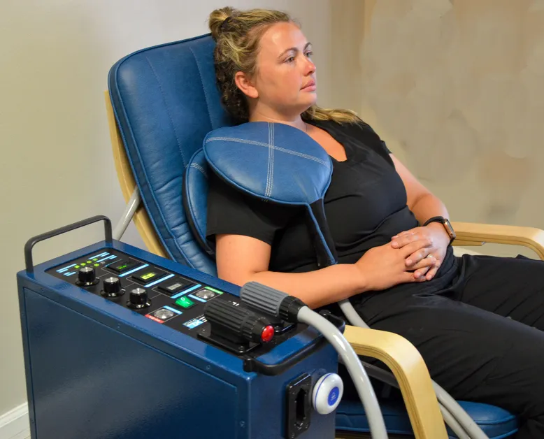 Guest receiving targeted PEMF therapy in the chair at iCRYO Port St. Lucie